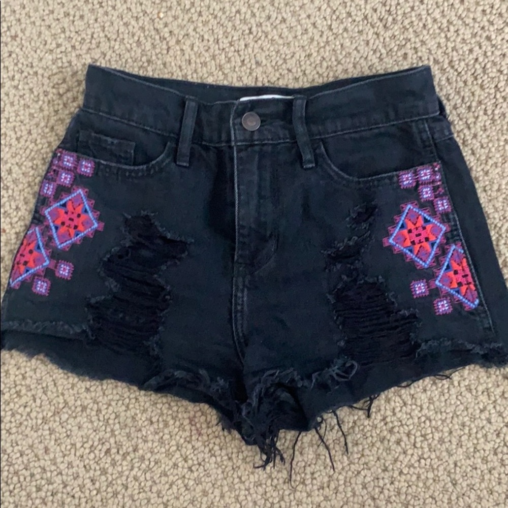 Black patterned shorts with rips